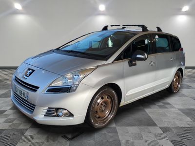 a picture of a silver minivan parked in a garage