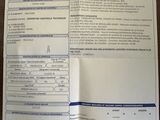an image of a car registration form is shown on a table