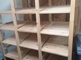 a close up of a shelf with several shelves and a trash can