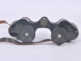 a pair of binoculars that are sitting on a white surface