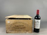 an old wooden box with a bottle of wine next to it