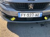 the front of a silver car with a lion on it ' s grill
