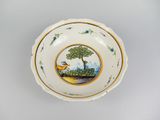 a white bowl with a bird and a tree on it