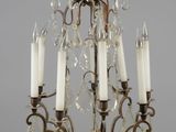 a close up of a chandelier with five candles on it