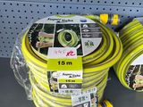 yellow garden hoses are on display in a store for sale