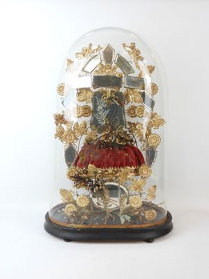 a glass dome with a gold decoration on top of it