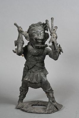 statue of a man holding a knife and a bottle in his hand