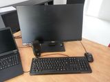 two laptops and a keyboard on a desk