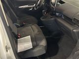 the interior of a car with the door open and the driver ' s seat down