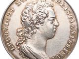 a close up of a silver coin with a woman ' s head