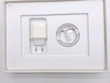 a white box with a charger and a cable attached to it