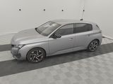 a silver car parked in a garage with a checkered floor
