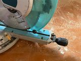 someone is using a circular saw to cut a piece of wood