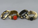 three different rings with different designs on them sitting on a table