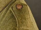 the back of a man ' s jacket with a button on it