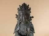 an image of a statue of a buddha sitting on a white surface