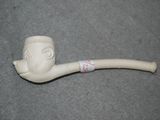 a pipe with a man ' s face on it sitting on the floor