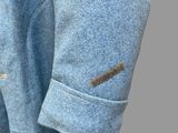 a close up of a blue jacket with buttons on it