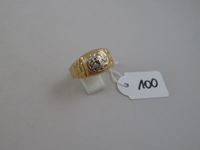 a gold ring with a lion on it and a price tag attached to it