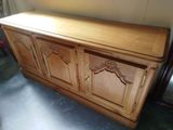 a wooden cabinet that has a door on top of it