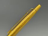 an image of a gold colored pen with a metal tip