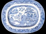 blue and white platter with oriental scene on it on a black background