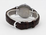 wrist watch with brown leather strap on white surface