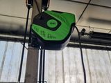 a green and black object hanging from the ceiling