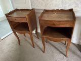 two wooden tables with drawers on them in a room