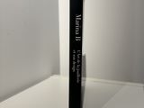 a black book that is sitting on a white table