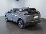 the rear of a silver car is parked in a showroom