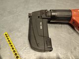 a cord nailer and a drill on a table