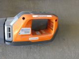 an orange and gray handheld vacuum on the ground