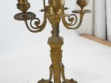a brass candelab with three candles on it