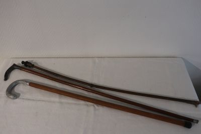 two canes and a pair of scissors on a table