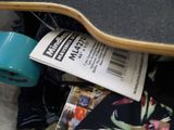 a skateboard that is laying on the ground with a roll of tape