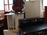 a black desk in a room with a lot of boxes on the floor