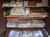 a cabinet with a lot of folded cloths in it