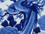 a blue and white plate with a bird and flowers on it