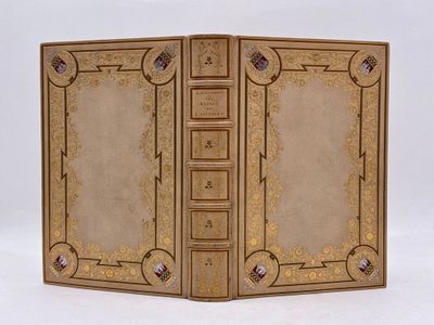 un vieux livre à la couverture dorée et ornée d'un motif décoratif
