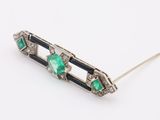 a close up of a pair of emerald and diamond hair pins