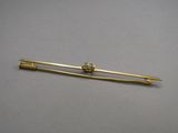 yellow gold plated tie bar with a flower design