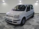a small white car parked on a checkered floor