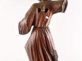 wooden statue of a man holding a cross on a white background