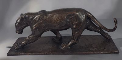 bronze statue of a tiger on a marble base on a gray background