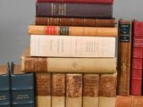 many books stacked on top of each other on a table