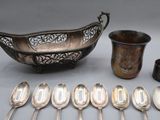 many spoons and cups and a bowl on the table