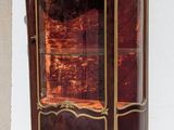 a cabinet that has a glass door on top of it