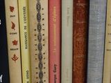 several books are lined up in a row on a table