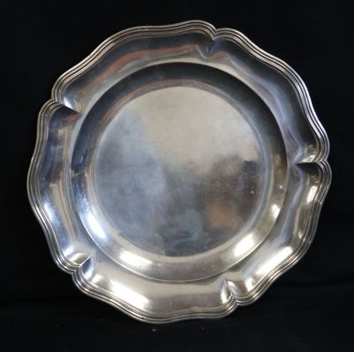 silver plate with scalloped edge on a black background